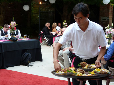 a man handling plates of food for an event